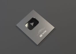 YouTube Silver Button Award for achieving 100K subscribers displayed on a table